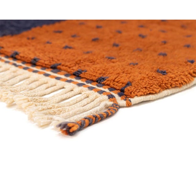 Bold contrast, minimalist restraint. This hand-knotted Moroccan wool rug pairs a rich cocoa upper block, detailed with a...