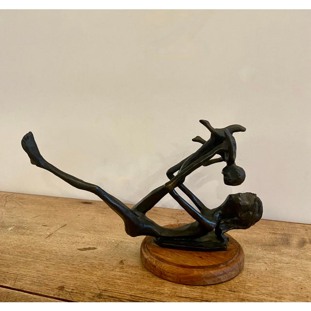 Lovely bronze sculpture of a woman and child. It beautifully captures the action and movement of a child being held aloft...