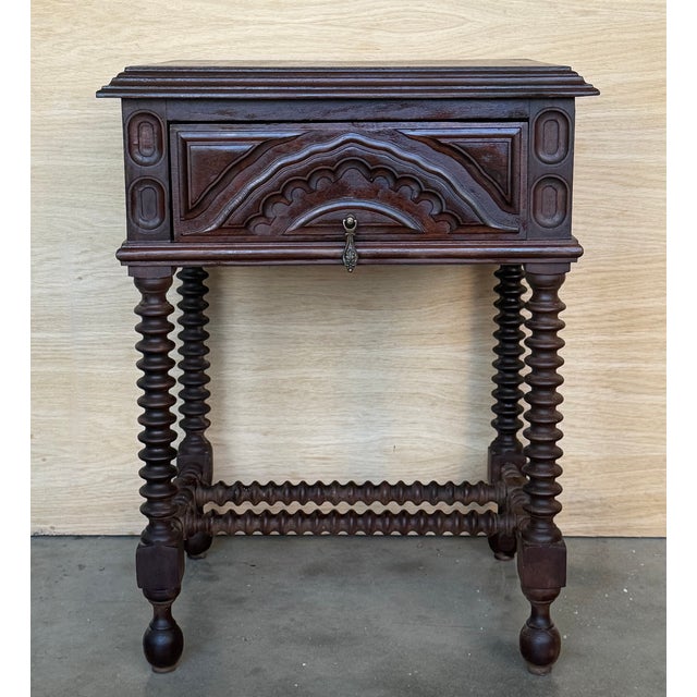 19th century pair of solid carved Spanish nightstands with Solomonic columns and carved drawers. The pieces have a...