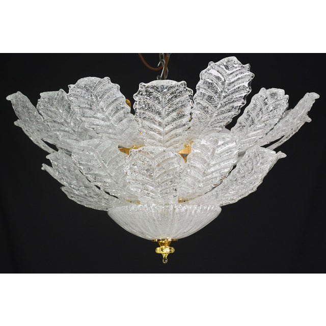 Stunning large ceiling lamp in Murano glass with transparent glass leaves on two levels. Period: circa 1970. The lamp has...