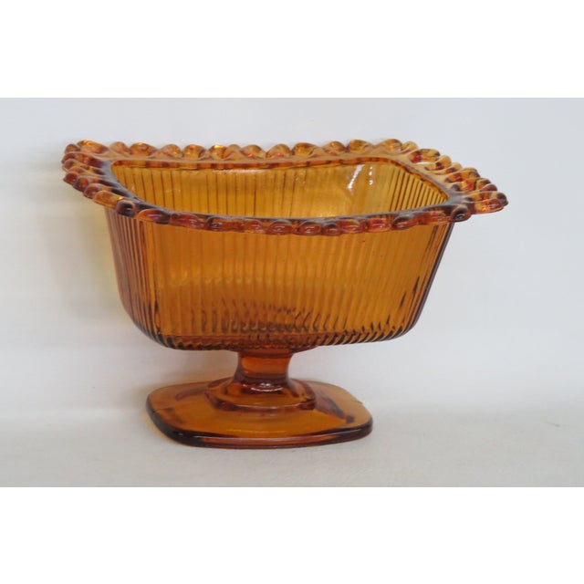 This beautiful Pedestal Dish is made of glass. This stunning dish is marked as being copyright by F.T.D.A 1981 on the...
