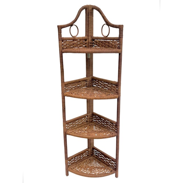 A charming pair of vintage 1980s woven rattan folding corner shelving units, perfect for adding warmth and texture to any...