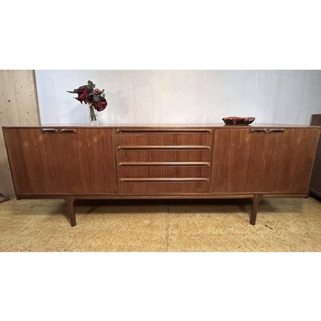 This rare and stunning mid-century teak sideboard was designed by tom robertson for a.h. Mcintosh in the 1960s. Known for...
