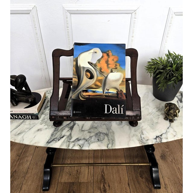 Unique and decorative bookstand with carved back and detailed in the frames and with its warm patina. It can look great on...