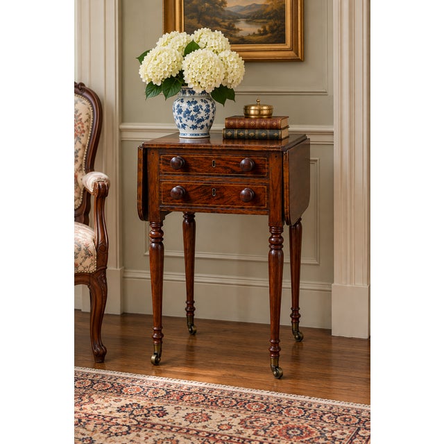 A handsome English Regency rosewood work table dating to approximately 1820–1840, displaying the refined proportions,...