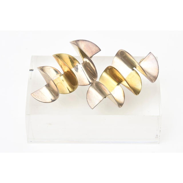 These vintage 2 tone brass metal and silver metal zig zag dangle sculptural pierced earrings are from the 70's. They are...