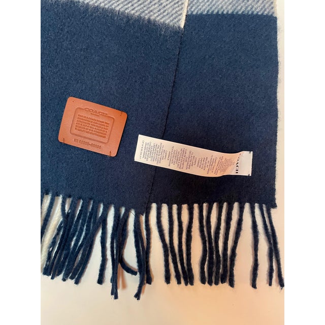 Cozy, fluffy, and warm navy and off-white giant buffalo plaid with 3” fringe and leather label. The photo looks more...