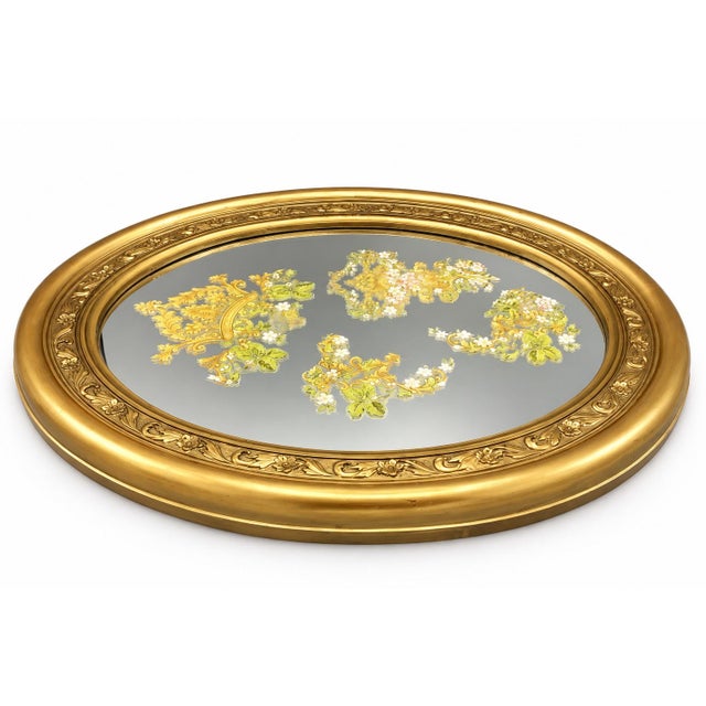 This decorative oval reproduction print features an elegant floral and botanical motif in soft blue, cream, and gold...