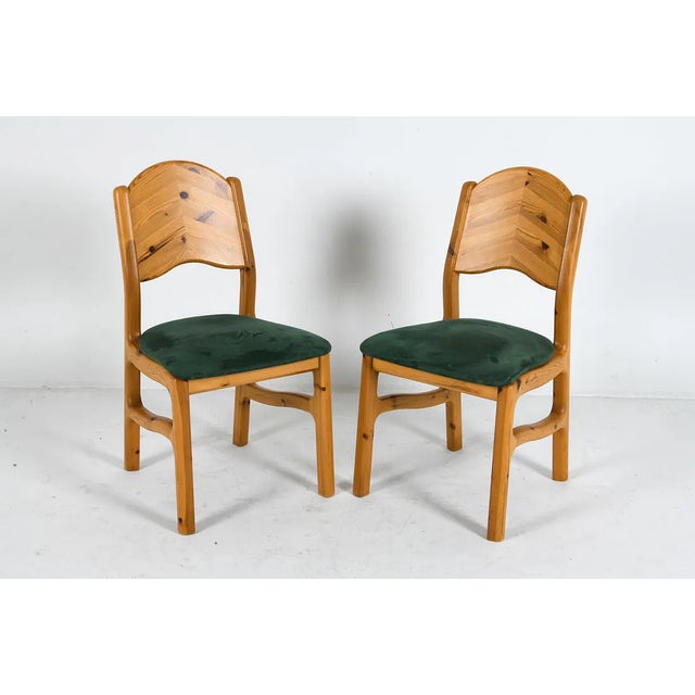 A pair of solid pine dining chairs produced in Denmark in the 1970s, designed in the style of Rainer Daumiller’s...