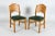 A pair of solid pine dining chairs produced in Denmark in the 1970s, designed in the style of Rainer Daumiller’s...