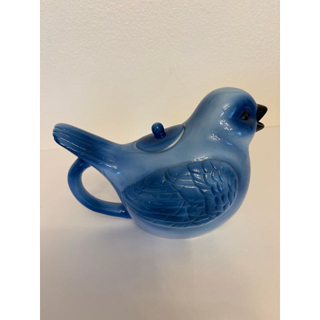 This vintage chinoiserie style mid-20th century blue bird shaped cermic vessel often used as a small teaport or...