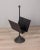 Magazine rack with cast iron base and black metal structure, Porada arredi design, 1980s. This piece has an attribution...