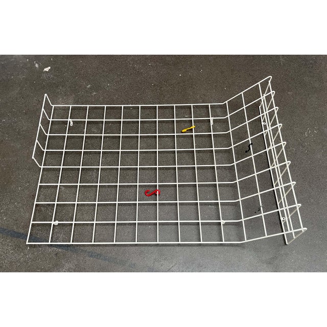 Minimalist Mid-Century Wire Coat Rack. A simple coat rack made of coated metal mesh. The upper section and part of the...