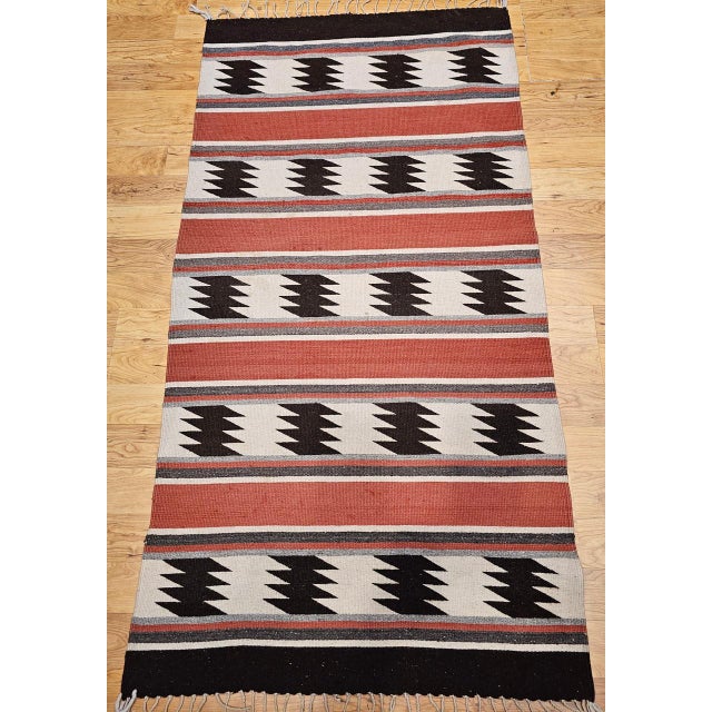 Add timeless style and cultural depth to your space with this vintage Native American Navajo area rug, handwoven in the...