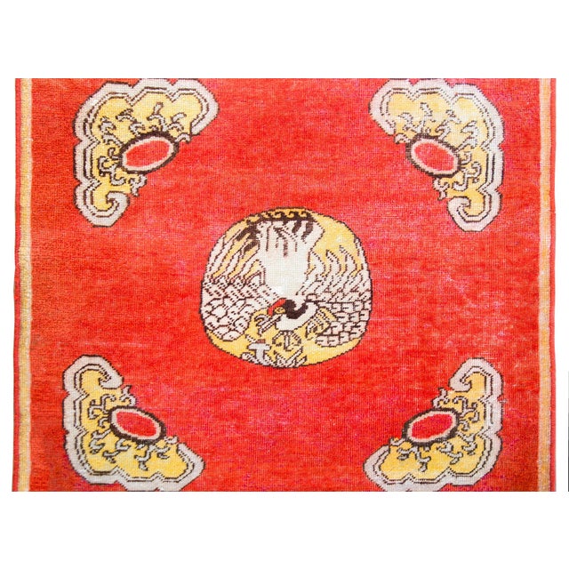 A charming early 20th century Central Asian Khotan rug styled after a traditional Chinese Rank Badge, with a large swan in...