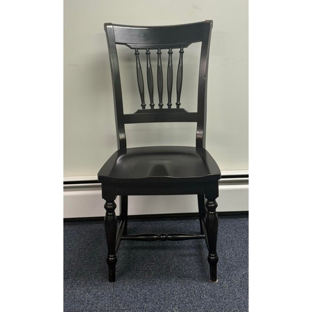 Beautiful set of six solid wood dining chairs featuring a timeless traditional design and a distressed black finish. Each...
