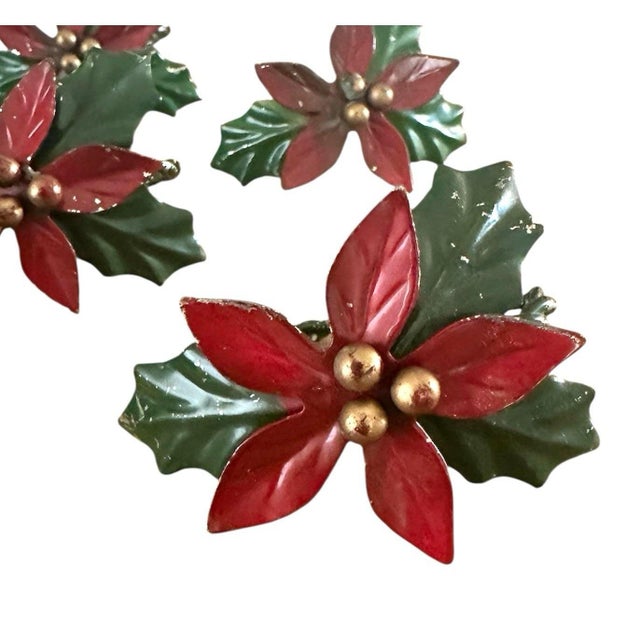 A lovely set of vintage tole napkin rings. Each features a five petal poinsettias accented by gold centers and surrounded...
