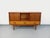 Vintage low sideboard from the 1960s, crafted from teak-style mahogany, ash, and beech wood, with black handles. Original...