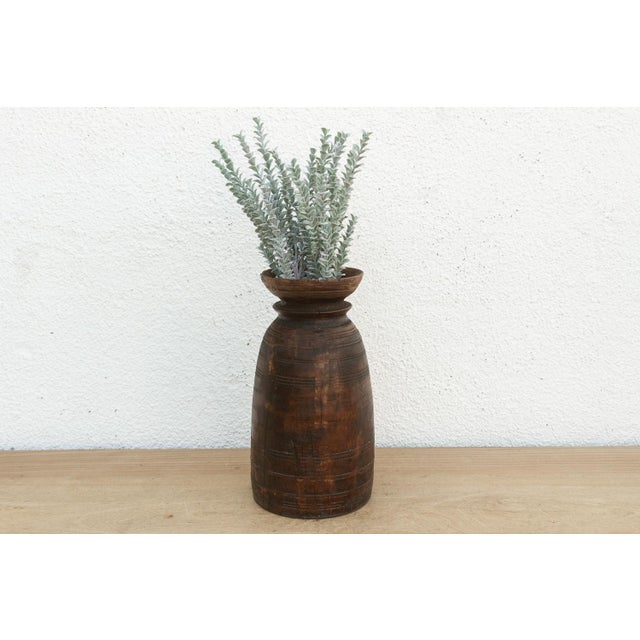 Originally used in village homes for storing milk, ghee, or grains, this antique wooden pot has survived generations of...