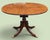 An elegant English Regency Revival oval extension dining table by the distinguished New York cabinetmakers Schmieg &...
