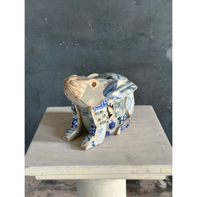 A fantastic composition of Zhangzhou Swatow Ming Porcelain shards set on a heavy stone like base of seated rabbit form....