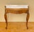 Elegant pair of French Louis XV style side tables, crafted from wood and featuring beautiful shaped marble tops. Each...