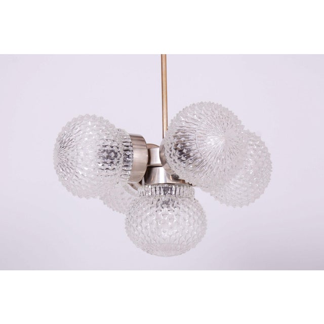 This chandelier is an excellent example of 1960s Czechoslovak lighting design, produced in the renowned glassworks of...