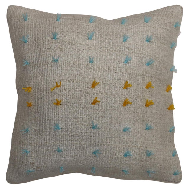 Pillow made from a vintage Turkish Kilim with yellow and blue wool stitched on giving it a bohemian vibe. Zipper closure...