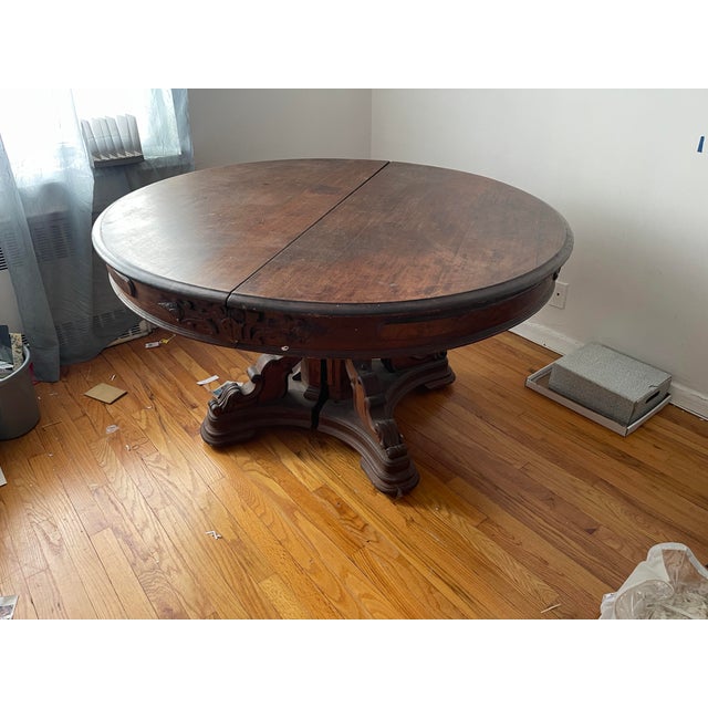 A commanding piece of late 19th century American furniture. This large round extension dining table features an...