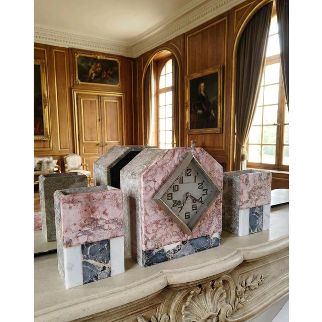 Elegant and highly decorative French Art Deco mantel clock garniture set dating from the early 20th century, circa 1930....