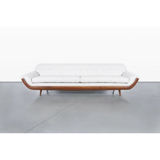 Inspired by the celebrated designs of Adrian Pearsall, this vintage walnut Gondola sofa captures the sculptural spirit...