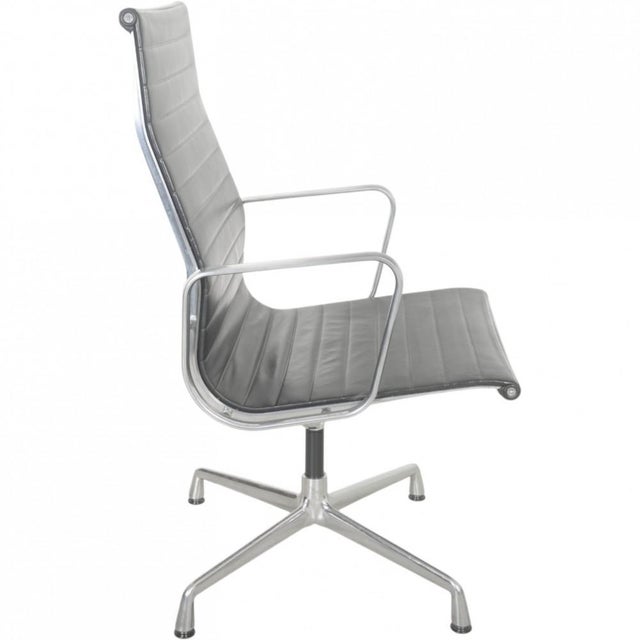 Charles Eames EA109 office chair upholstered in black leather and with a frame of aluminium. The chair is from 2007 and...