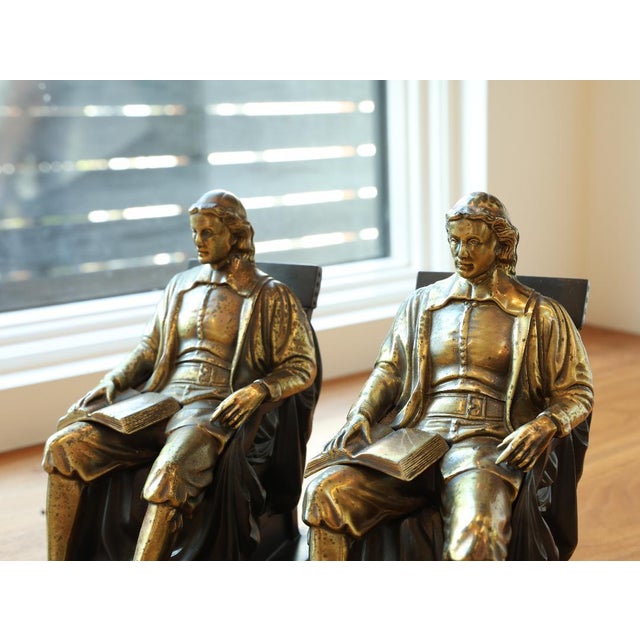 A handsome pair of antique John Harvard bronze-clad bookends, modeled after Daniel Chester French’s celebrated 1884 John...