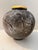 Vintage studio pottery vase featuring a rounded, sculptural form with a striking black and gray drip glaze finish. This...
