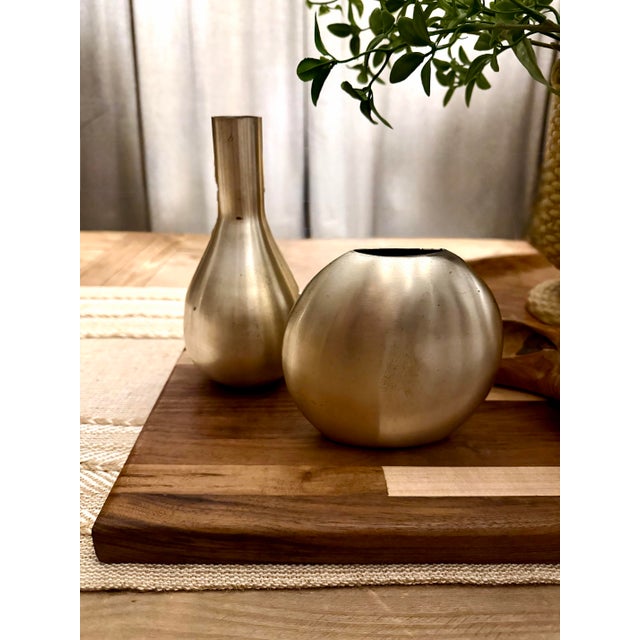 Elevate your space with this set of two authentic Crate & Barrel “Cooper” vases, featuring a sleek brushed metal finish...