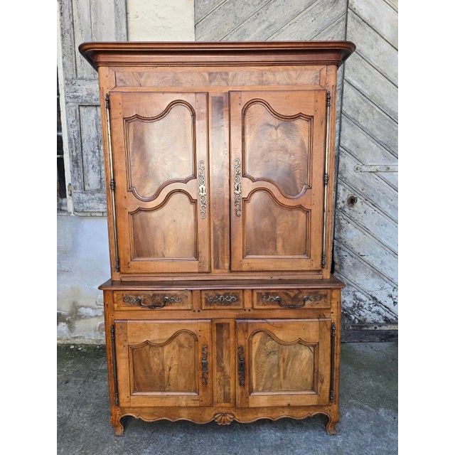 A two-part louis xv period buffet, crafted from solid walnut, boasting a beautiful antique patina and exquisite joinery....