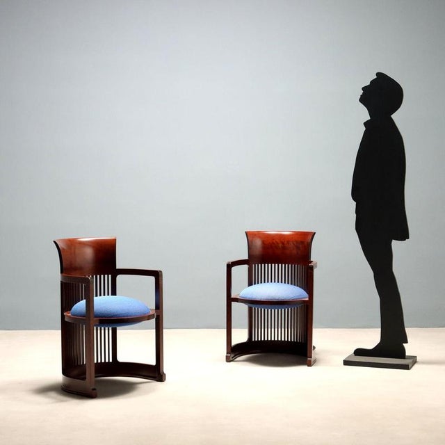 Pair of armchairs with cherry wood frames and blue fabric seats. In good overall condition, they show signs of wear, as...