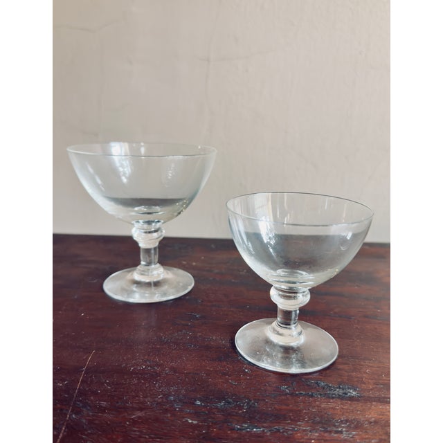 This is a vintage Mid-Century Modern clear glass stemware set. The glasses feature wide, shallow bowls and short stems,...