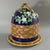 George Jones Majolica cheese keep which features a branch handle with apple blossoms. Basketweave to the sides. Cobalt...