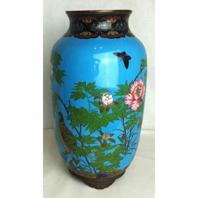 This vibrant vase will bring color and charm to your space! We believe it depicts a spotted dove. A beautiful piece, we...