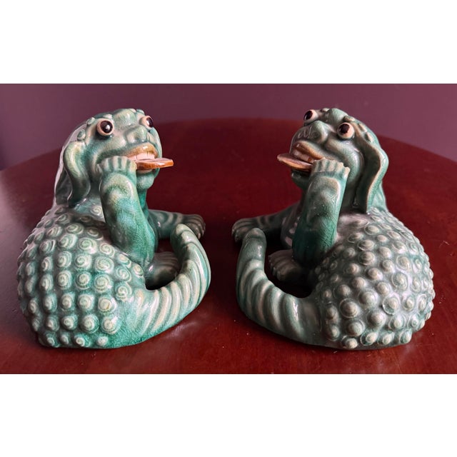 Very fun pair of Chinese Foo Dogs / Dragons with coins in their mouths which bring good fortune and good luck. Very fun.