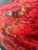 Striking abstract artwork, by Dallas artist Tammera White, featuring a vibrant crimson-red center framed by a dramatic...