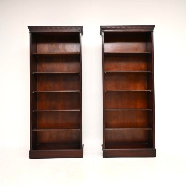 A tall and useful pair of antique Georgian style open bookcases, made in England and dating from around the 1950’s. They...