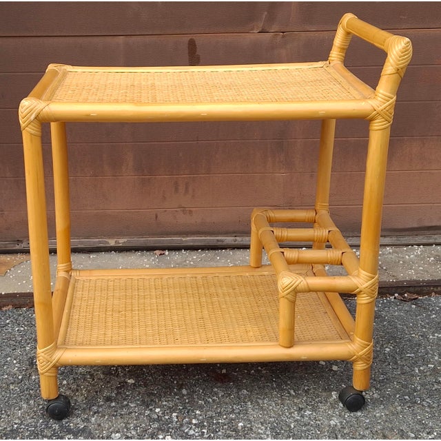 A beautiful handcrafted Late 20th Century Rattan and Cane Rolling Bar Cart. Measures 27" in width, 18.5" in depth and...