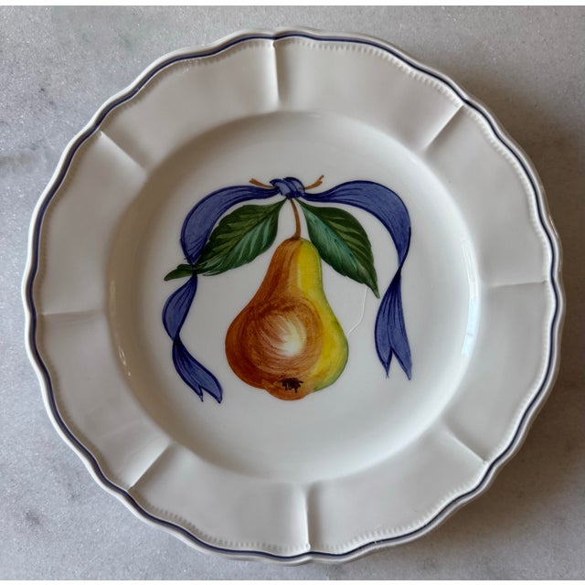 Set of 4 hand painted lunch plates in the French Bistro pattern featuring a scalloped edge and a central pear with a blue...