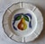 Set of 4 hand painted lunch plates in the French Bistro pattern featuring a scalloped edge and a central pear with a blue...