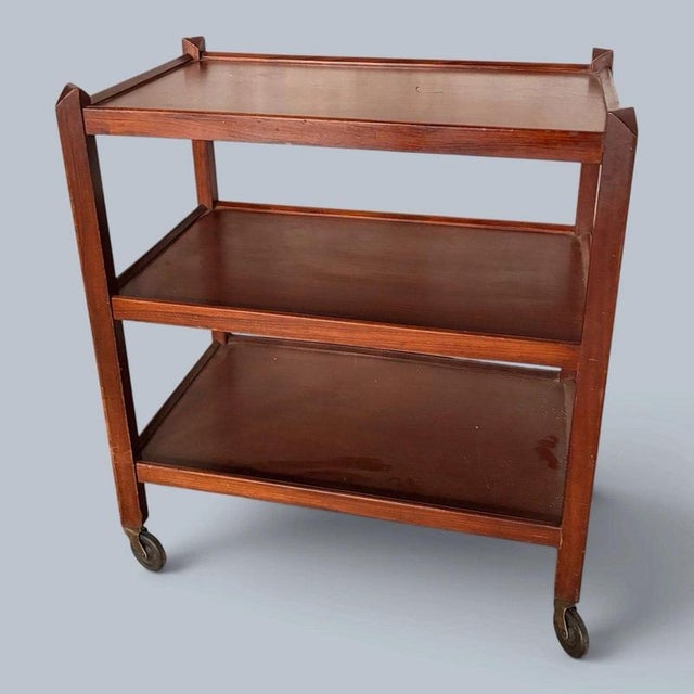 a versatile mid-century wooden drinks trolley with three useful tiers and four castors. Ideal as a cocktail bar cart, tea...