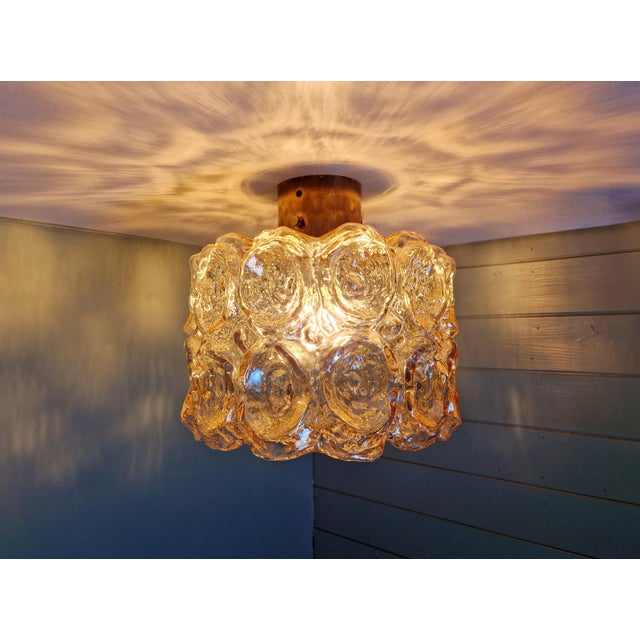 Ceiling light in brass and textured amber glass, design attributed to helena tynell, for the german manufacturer glashütte...