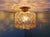 Ceiling light in brass and textured amber glass, design attributed to helena tynell, for the german manufacturer glashütte...