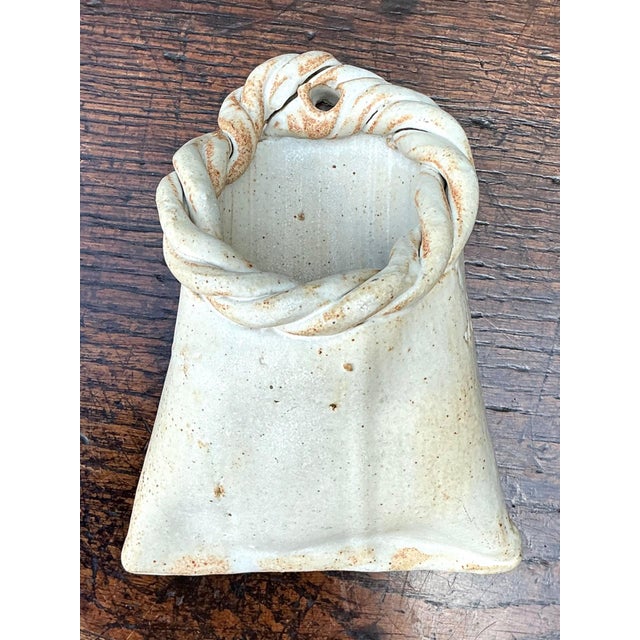 This vintage stoneware wall pocket by Tracy is a charming example of handcrafted studio pottery, combining sculptural...
